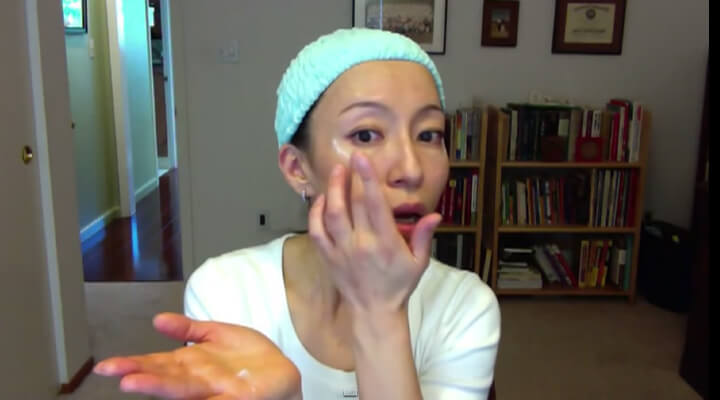 Fumiko Takatsu putting on a moisturizing cream on her face.