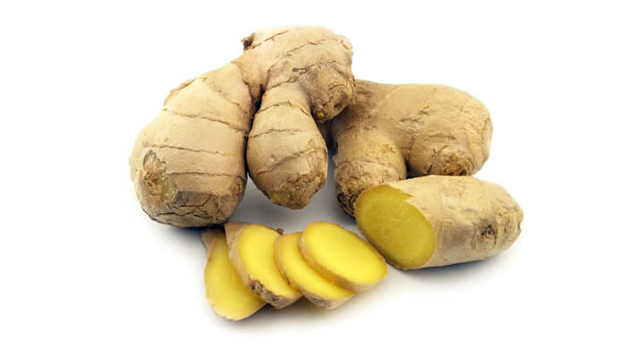 Ginger root and sliced ginger root, white background..